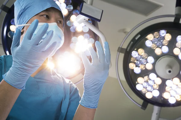 Surgeon holding gloved hands up — Stock Photo, Image