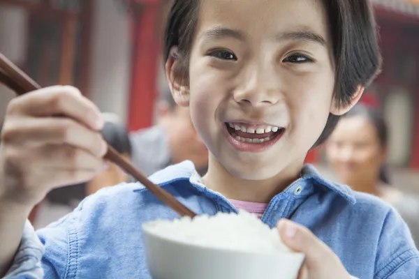 Klein meisje eten rijst — Stockfoto