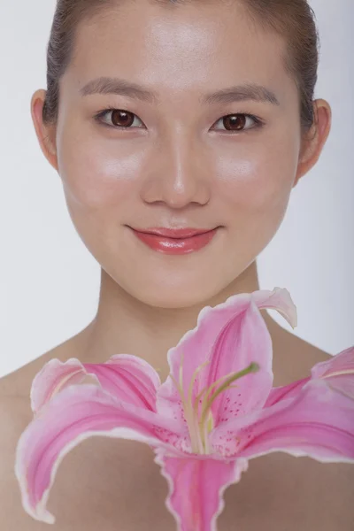 Woman with a large pink flower — Stock Photo, Image