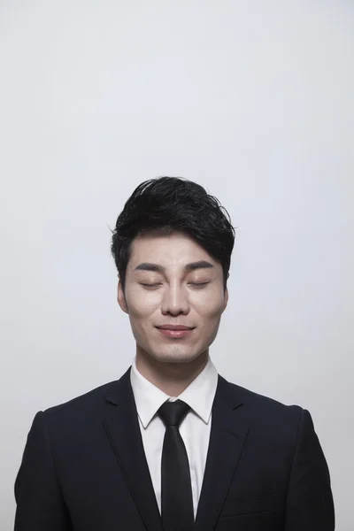 Businessman with eyes closed — Stock Photo, Image