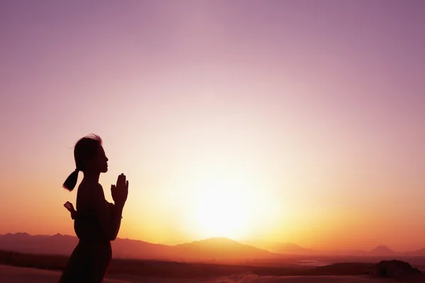 Woman with hands together in prayer pose in the desert — Stock Photo, Image