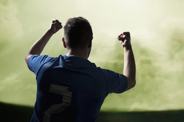 Soccer player with arms raised cheering — Stock Photo, Image