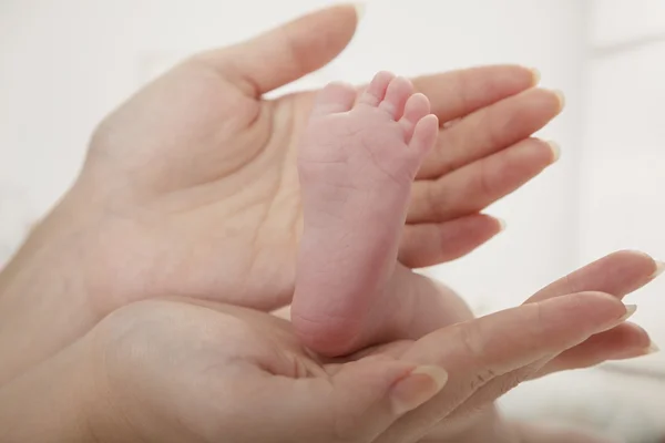 Matka, trzymając nogi jej dziecka — Zdjęcie stockowe