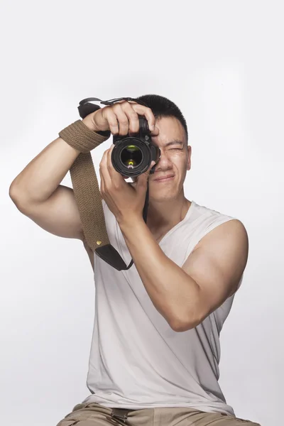 Hombre sosteniendo una cámara y tomando una fotografía — Foto de Stock