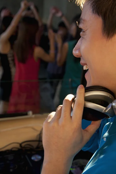 DJ laughing and watching the dancing crowd — Stock Photo, Image