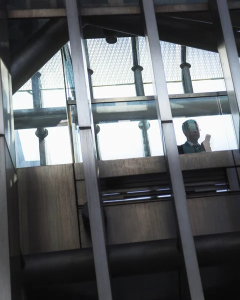 Businessman on the phone inside a modern building — Stock Photo, Image