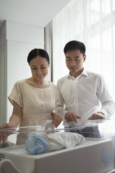 Family looking down at their newborn — Stock Photo, Image