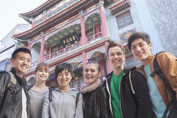 People with Chinese architecture in background