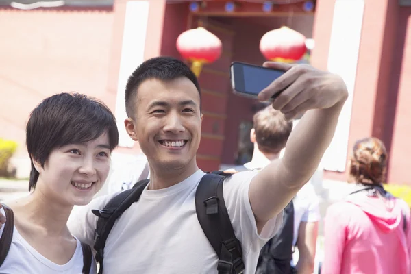 Young couple taking self portrait — Stock Photo, Image