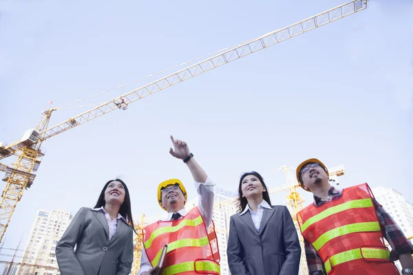 Architects and businesswomen at a construction site — Stock Photo, Image