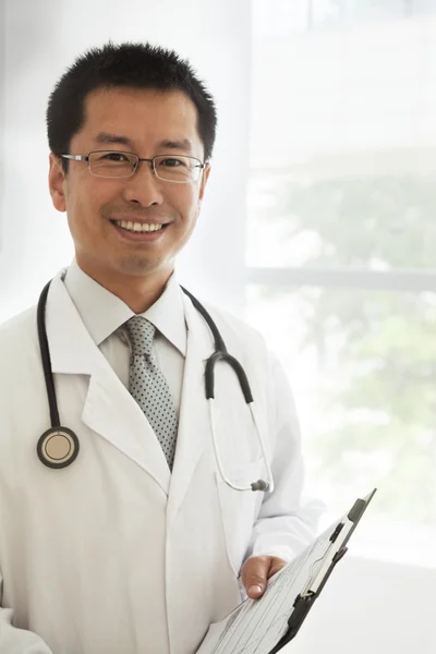 Doctor with a stethoscope and medical chart — Stock Photo, Image