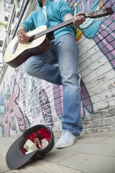 Young street musician playing guitar — Stock Photo, Image