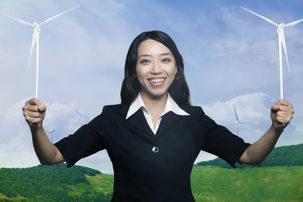 Woman holding to wind turbines — Stock Photo, Image