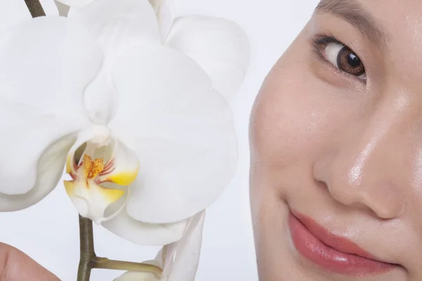 Frau mit weißer Orchidee — Stockfoto