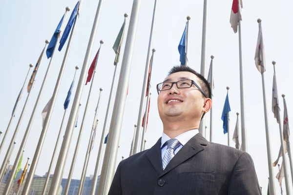 Young businessman with flags — Stock Photo, Image