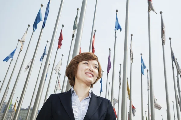 Young businesswoman with flags — Stock Photo, Image