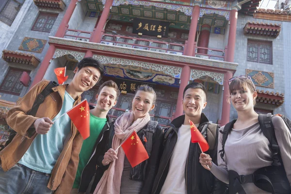 People holding Chinese flags — Stock Photo, Image