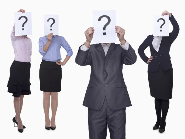 Business people holding up paper with question mark — Stock Photo, Image