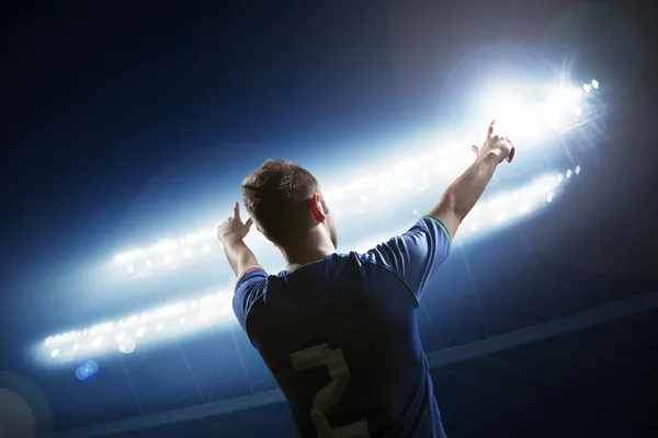 Soccer player with arms raised cheering — Stock Photo, Image