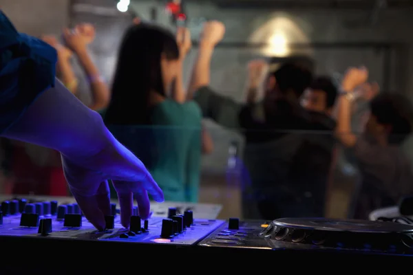 DJ fedélzeten a nightclub táncoló tömeg — Stock Fotó