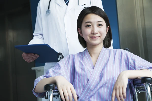 Female patient sitting in a wheelchair — Stock Photo, Image