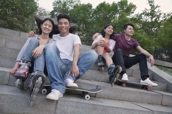 Couples resting on concrete steps — Stock Photo, Image