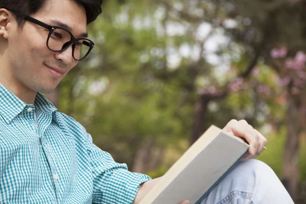 Man enjoying his book in a park — Stock Photo, Image