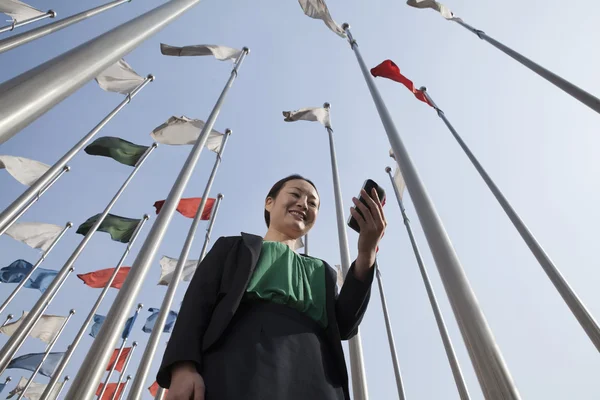 Businesswomen looking at mobile phone — Stock Photo, Image