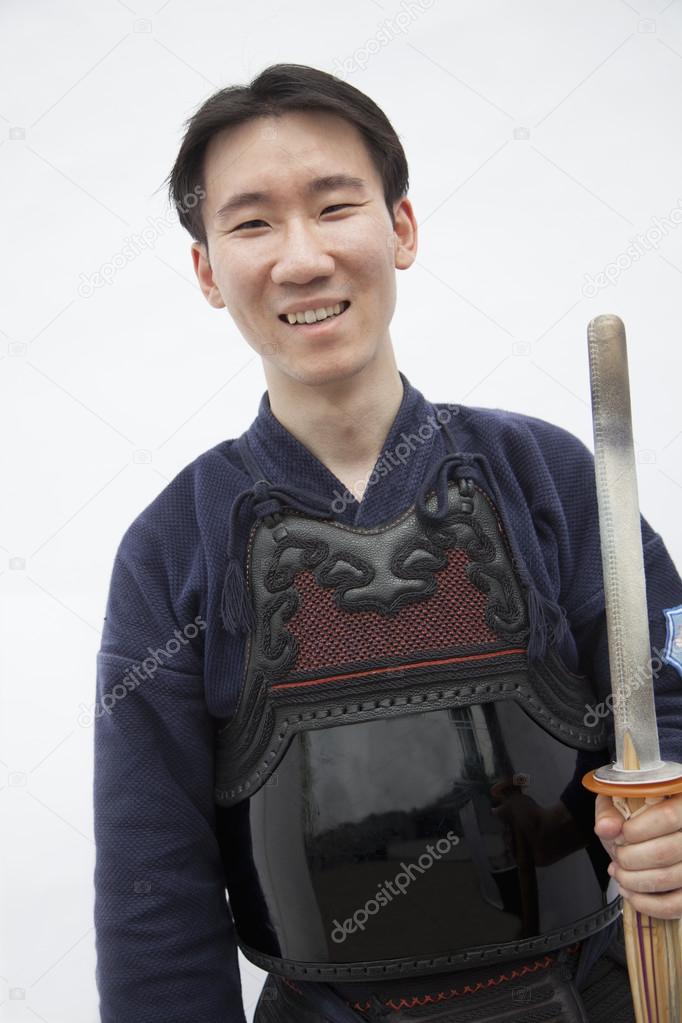 Man in traditional Japanese clothing holding a sword