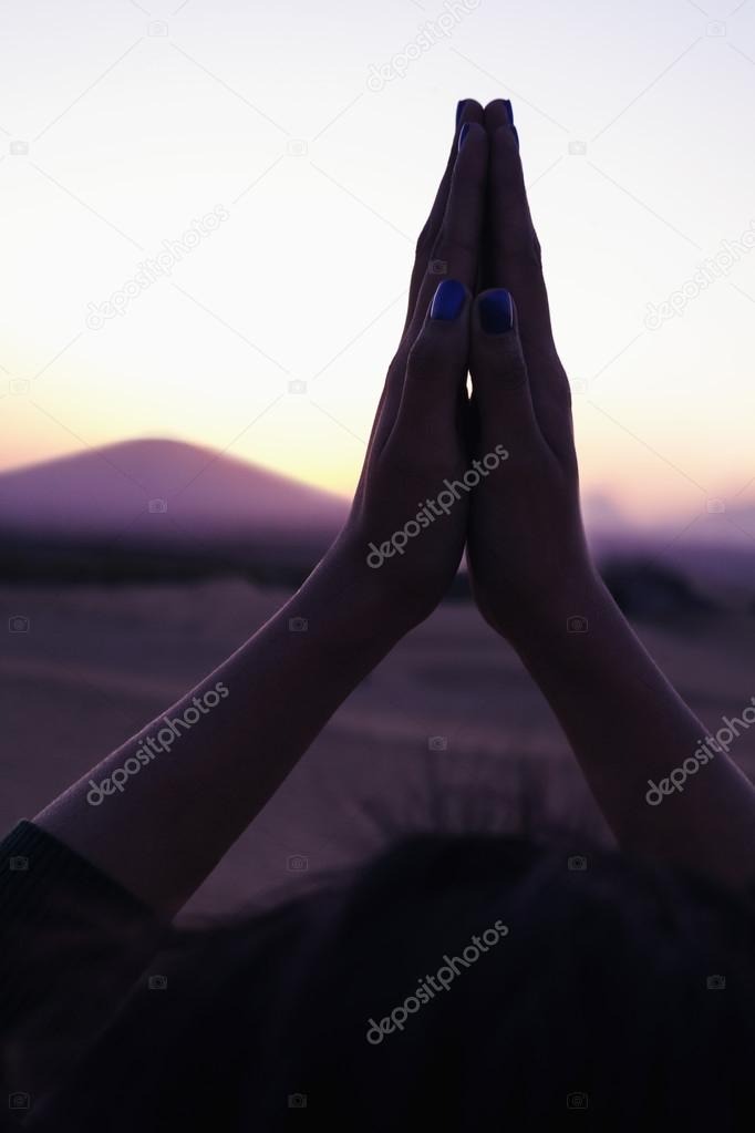 Woman with her palms together in prayer