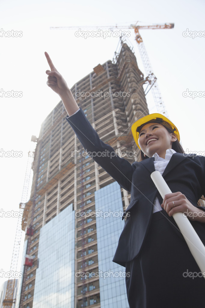 Architect pointing at a construction site