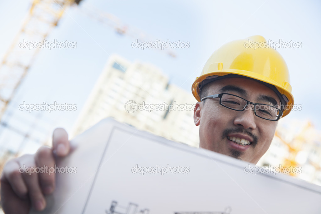 Architect looking at blueprint