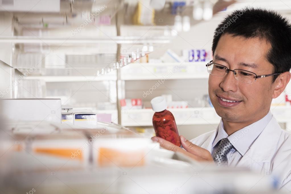 Pharmacist examining prescription medication