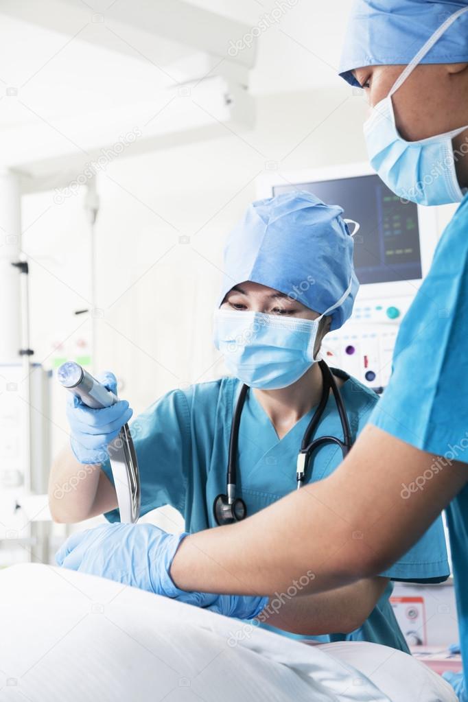 Surgeon holding surgical equipment in the operating room