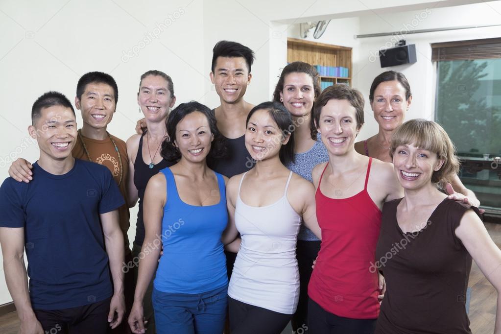 Smiling group of people in a yoga studio