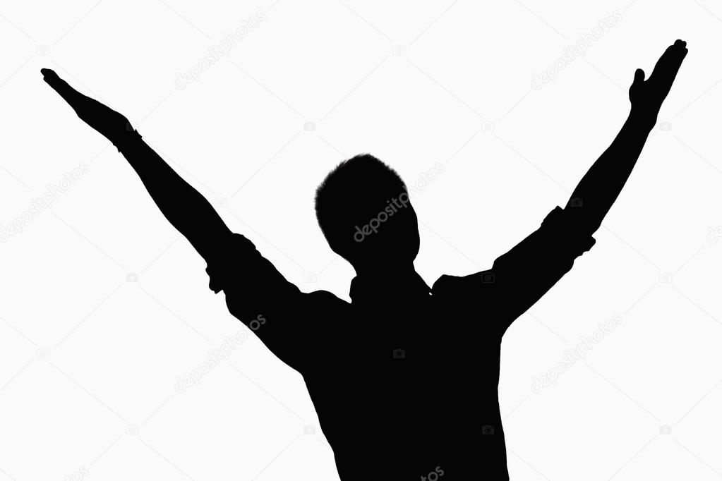 Silhouette of businessman with arms raised