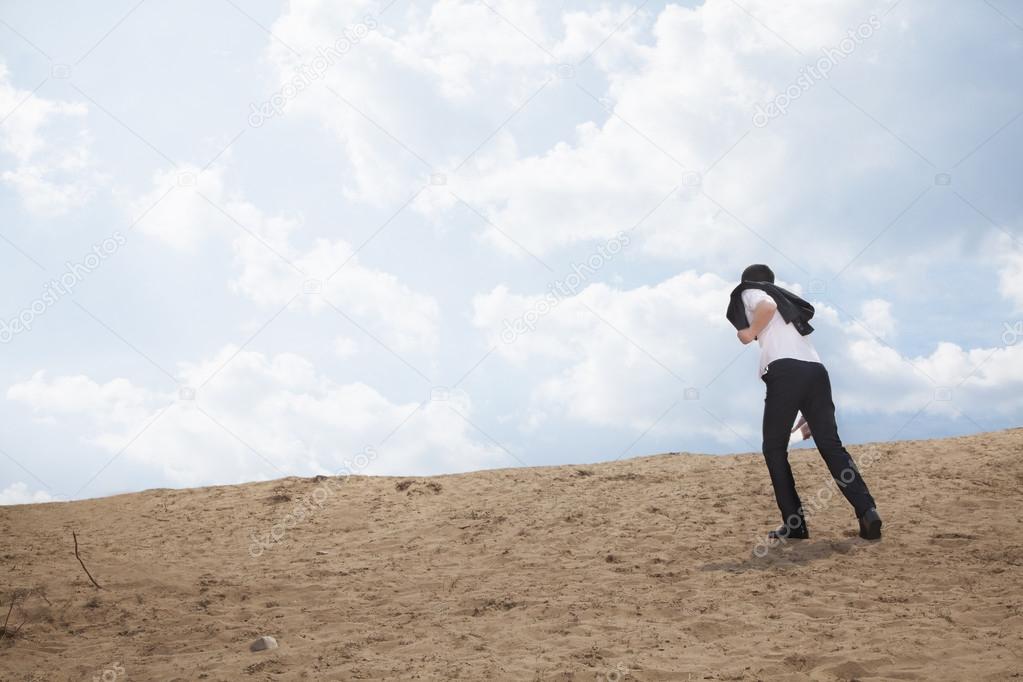 Businessman walking through the desert