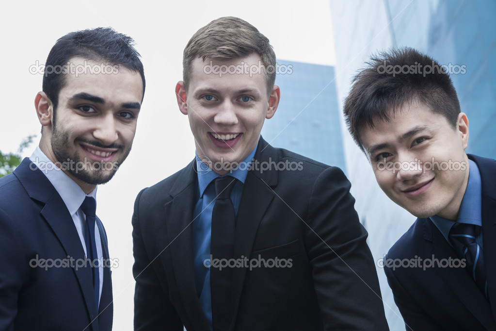 Three smiling businessmen outdoors