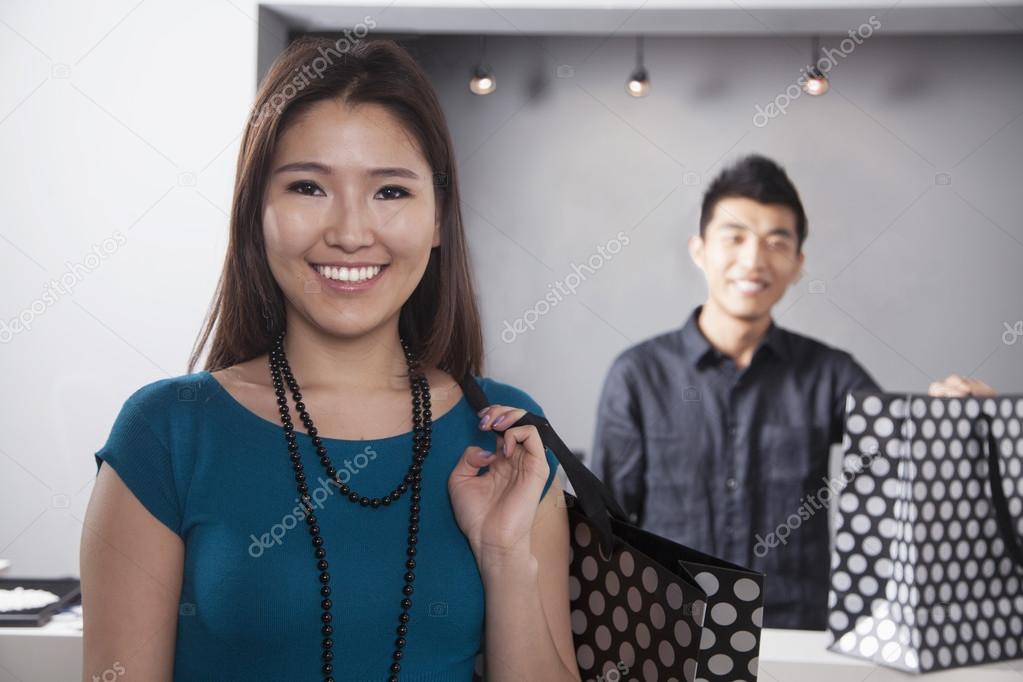 Young woman and man with shopping bags