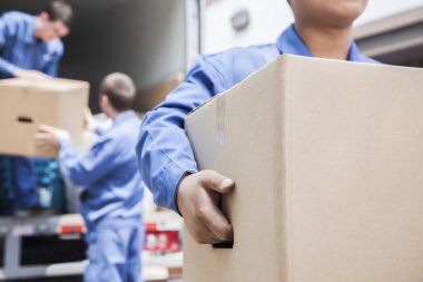 Movers unloading a moving van clipart