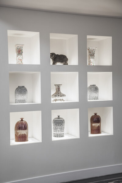 Built in shelves with an assortment of vase