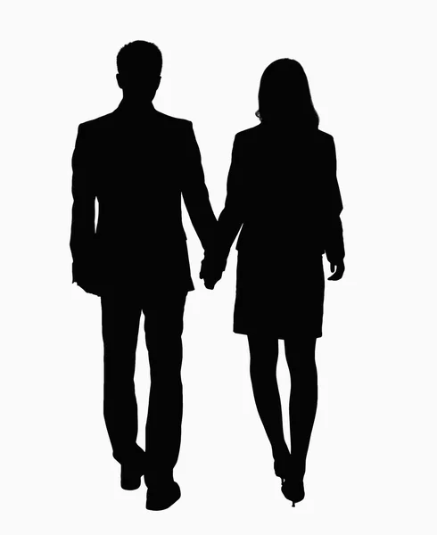 Silhouette of businessman and businesswoman holding hands — Stock Photo, Image