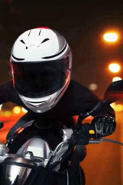 Man riding a motorcycle at night — Stock Photo, Image