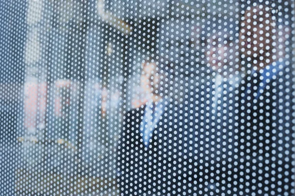 Business people behind a glass wall looking out — Stock Photo, Image