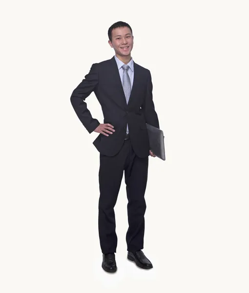 Young businessman holding a laptop — Stock Photo, Image