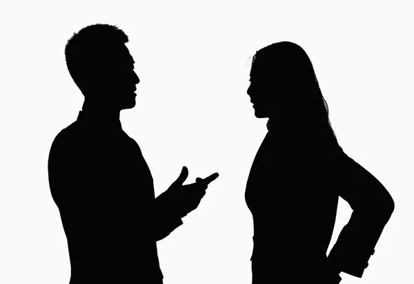 Silhouette of businessman and businesswoman talking — Stock Photo, Image