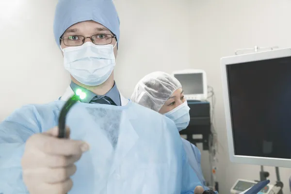 Surgeon holding a medical instrument — Stock Photo, Image