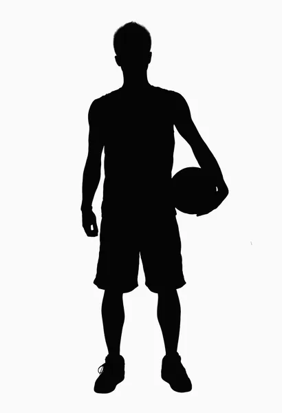 Sylwetka koszykarz trzymając piłkę — Zdjęcie stockowe