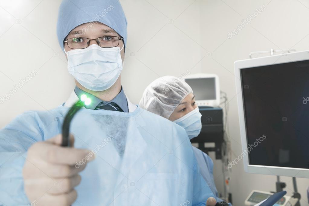 Surgeon holding a medical instrument
