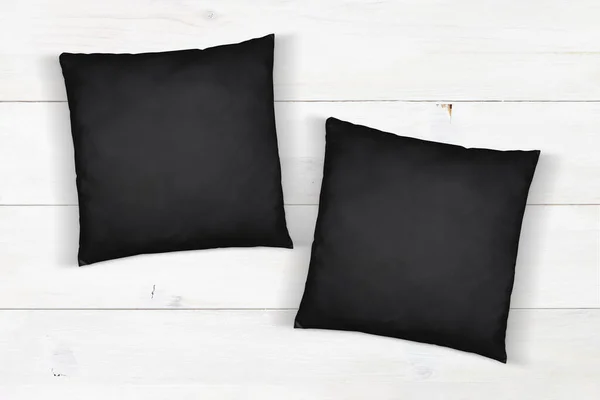 Two Black Throw Pillows Napping Atop Modern White Wood Background — Zdjęcie stockowe